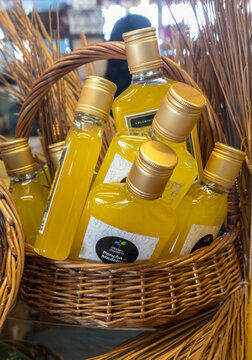 Funchal, Madeira, Portugal - April 19, 2018: Bottles of Ponchain a wicker basket at a street market stall in Funchal, Madeira. Portugal.