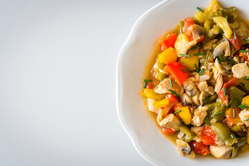 Chicken curry nuggets with grilled vegetables on a white plate. Space in left side