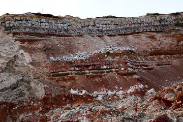 textures of various clay layers underground in  clay quarry after  geological study of  soil. colored layers of clay and stone in  section of  earth, different rock formations and soil layers.