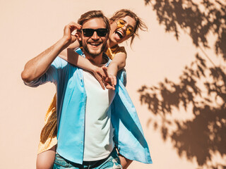 Portrait of smiling beautiful girl and her handsome boyfriend. Woman in casual summer dress and man...