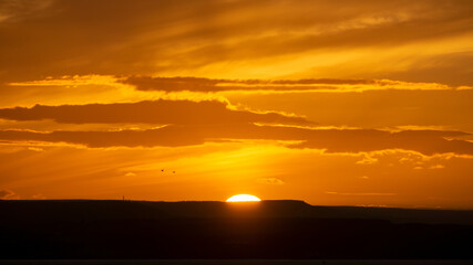 Fototapeta premium The sunsets over the sea near Thornwick Bay, Flamborough Head, East Yorkshire, UK
