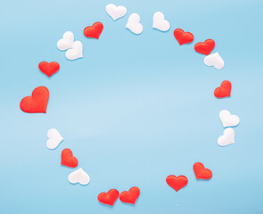 Red hearts symbol of love lined with a square frame on blue background