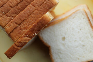 Brown white color raw bread pieces cropped and partial display with selective focus. Food background.