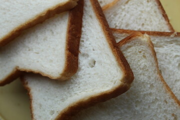 Brown white color raw bread pieces cropped and partial display with selective focus. Food background.