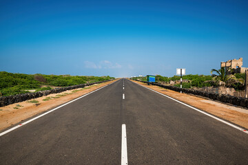 he black road heading straight ahead. Flanked by the sea at Dhanushkodi, Tamil Nadu, India.
