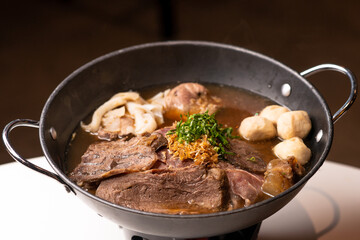 beef soup in black pan