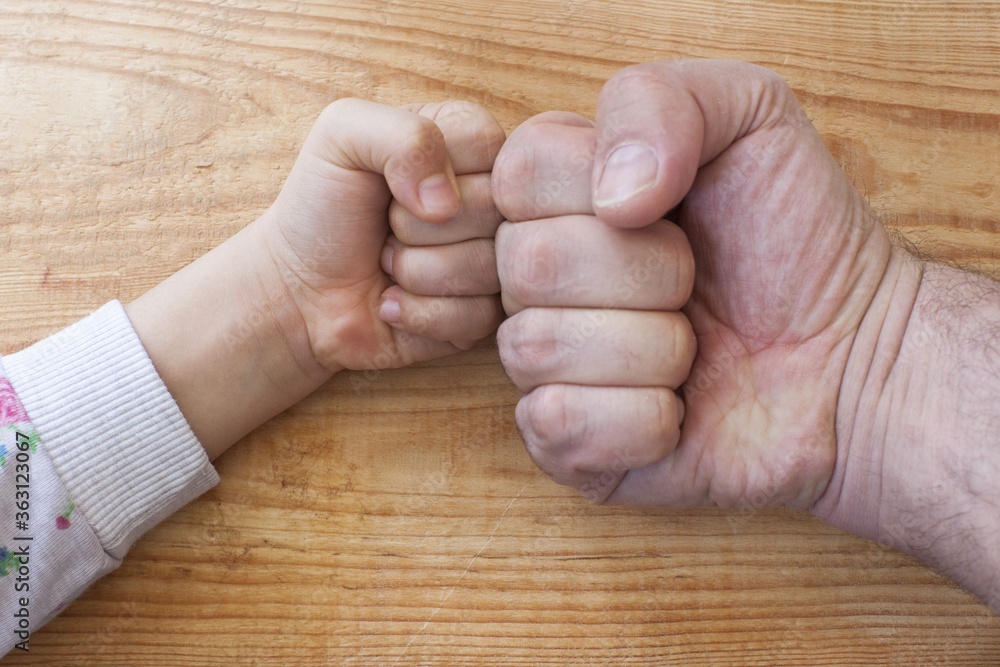 Canvas Prints Overhead shot of a young and an older person's hands fist bumping