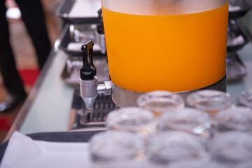 tap of orange juice cooler
