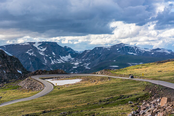 Fototapeta premium The bear tooth highway on top of mountains, shot on a cloudy day, summer time.