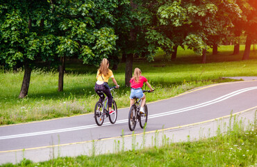 Cyclists ride on the bike path in the city Park