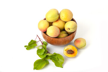 Fresh ripe apricots in wooden bowl isolated on a white background.