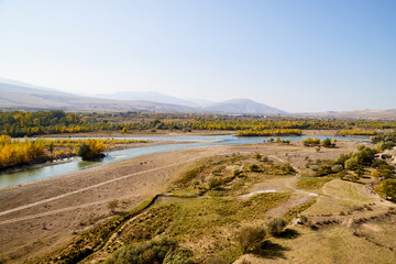 Autumn landscapes with fantastic views from mountain to valley and blue river. Colourful mountain nature in autumn, summer, or spring day