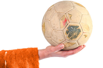 Old soccer ball in women's hand