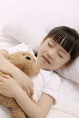 Obraz na płótnie Canvas Girl sleeping and hugging soft toy