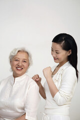 Woman massaging senior woman's back