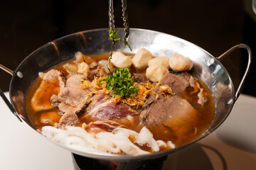beef soup in black pan