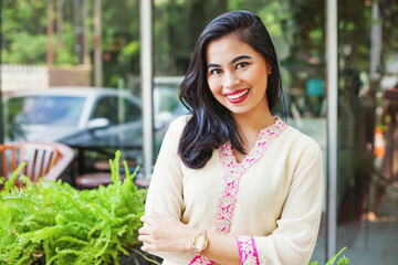 Beautiful asian woman posing in Indian traditional clothes (kurta) and looking at camera