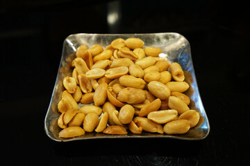 Close up plate of salted peanuts