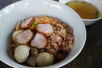 Close up dry pork noodles with soup
