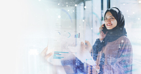 Muslim business woman talking on phone and reading document over abstract background of graphs and digital patterns