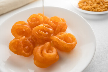 plate of indian traditional sweet with honey
