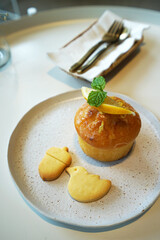 Close up lemon cupcake on white ceramic plate