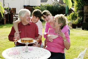 A girl and boy giving their grandparents a surprise visit