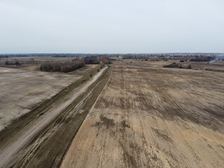 Fototapeta premium Dirt road in the fields, aerial view. Landscape.