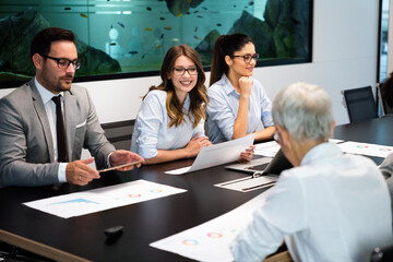 Happy diverse business colleagues meeting, working in modern office