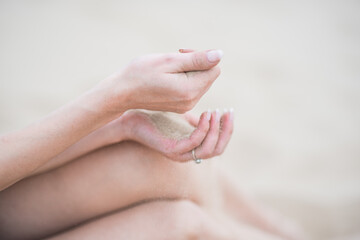 the sand pours in the hand in desert