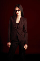 Studio shot of a lady in office attire wearing a sunglass