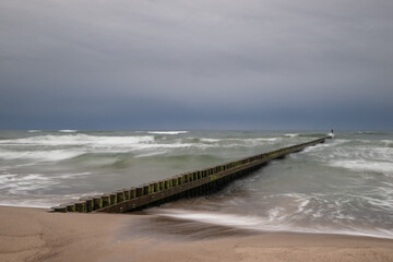 wzburzone morze i falochron palowy. Morze Bałtyckie plaża w Darłowie