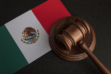Judge or auction gavel and flag of Mexico. Mexican legislation. Violation of human rights in Mexico