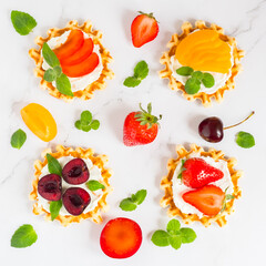 Top view of traditional Belgian waffles with soft cheese, fruits and berries. flat lay.