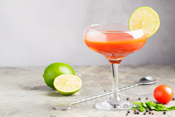 Bloody mary tomato juice cocktail and ingredients tomato, lime, celery, parsley. Strong drinks in elegant glass glasses