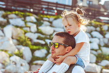 Obraz premium the child is sitting on the neck of the father