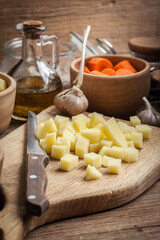 Diced potatoes on a wooden chopping board.