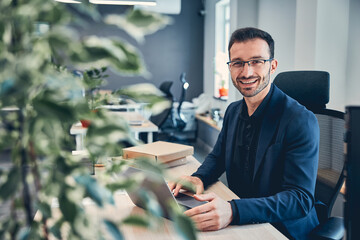 Portrait of a smiling businessman in his office