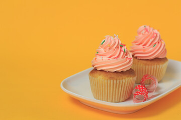 Pink cupcakes on a yellow background