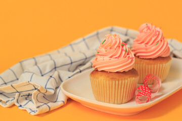 Pink cupcakes on a yellow background