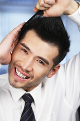 Businessman combing his hair