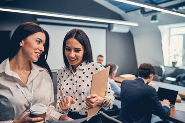Two female colleague in office at the coffee break