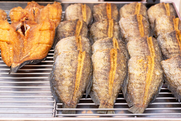 Fried Snake-head fish and Trichogaster pectoralis cut in stripes before fry for crisp.