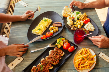 Group of friends having breakfast in the restaurant