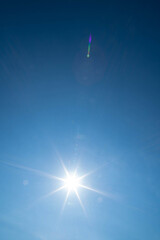 Sunbeams in the blue sky. Natural phenomenon. The nearest star of our system, i.e. the sun.