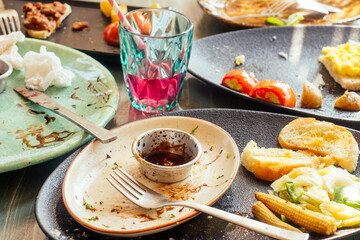 dirty dishes plates and glass on the table in cafe