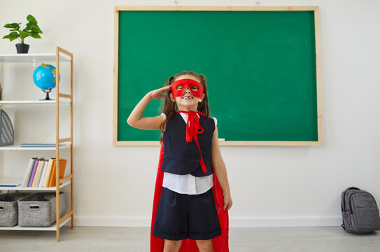 Children at school. Schoolgirl superhero fun laughing in a school class.