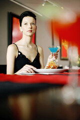 Woman enjoying her meal in a luxurious restaurant