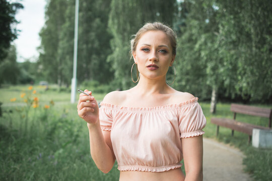 stylish teenager girl smokes a cigarette