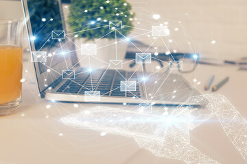 Desktop computer background in office and flying envelops hologram drawing. Multi exposure. Electronic mail concept.
